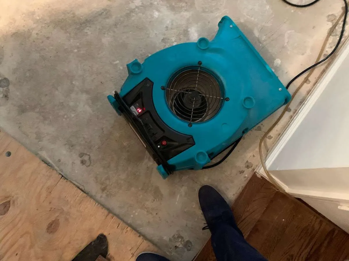 Air mover drying subfloor during Commercial Water Damage Restoration in Parkersburg